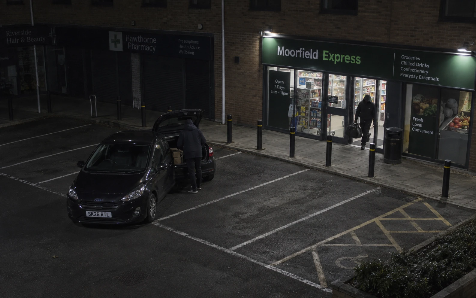 A British convenience store and its car park seen from an elevated camera position.