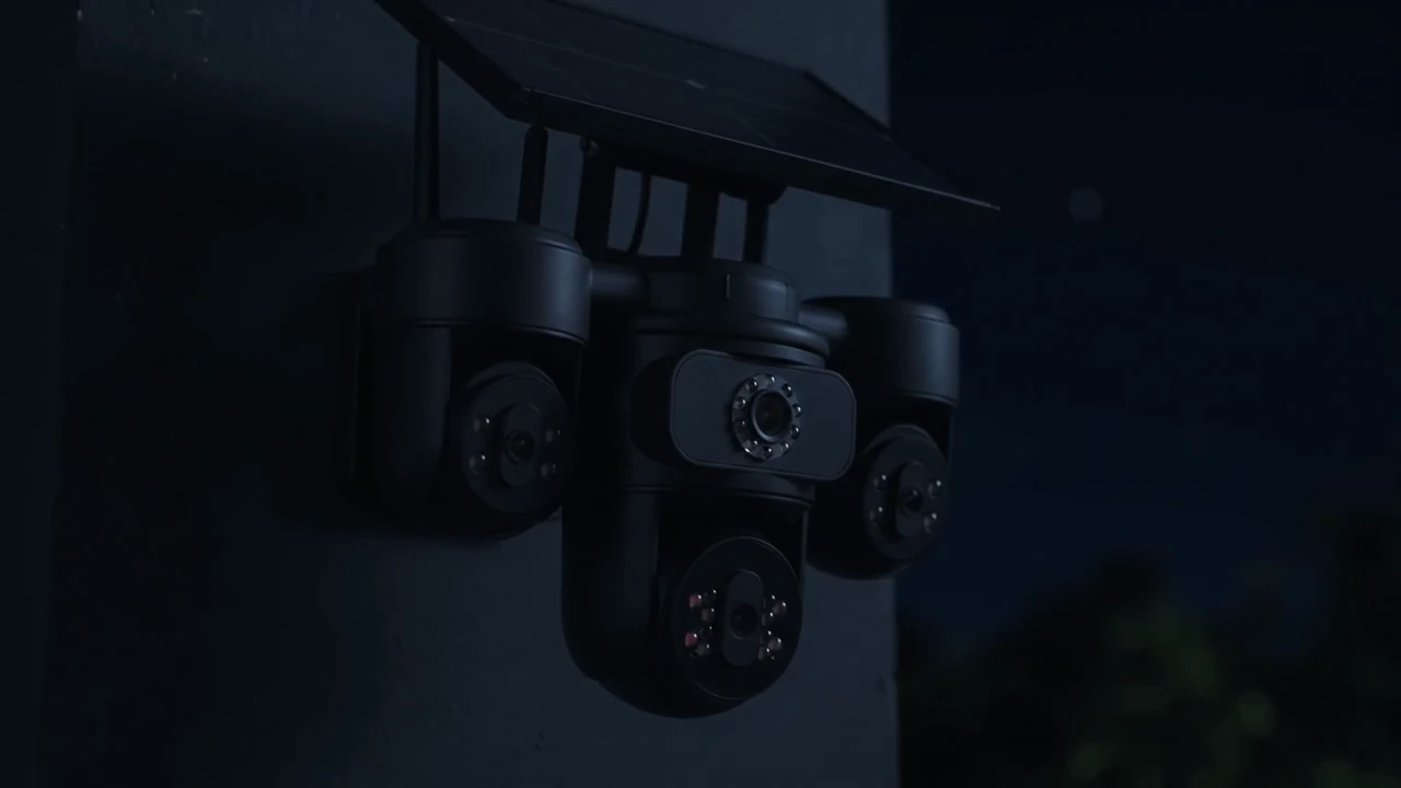 A solar-powered multi-lens security camera mounted on a pole at night